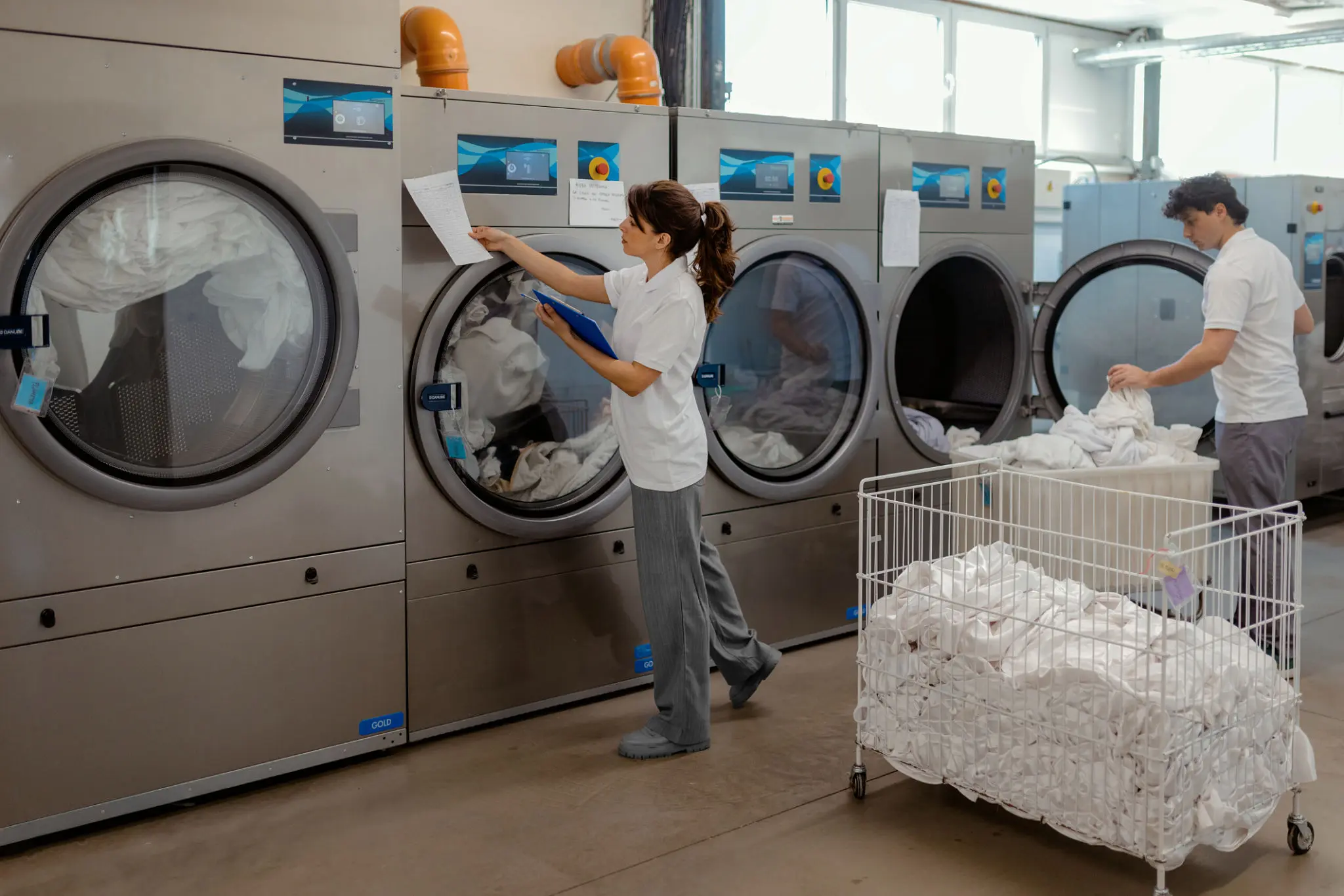 People working in a commercial laundry facility.